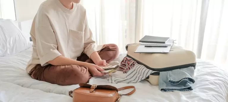 Travel.Suitcase.Girl traveler packing luggage in suitcase Travel,tourism,vacation,relocation.Mental